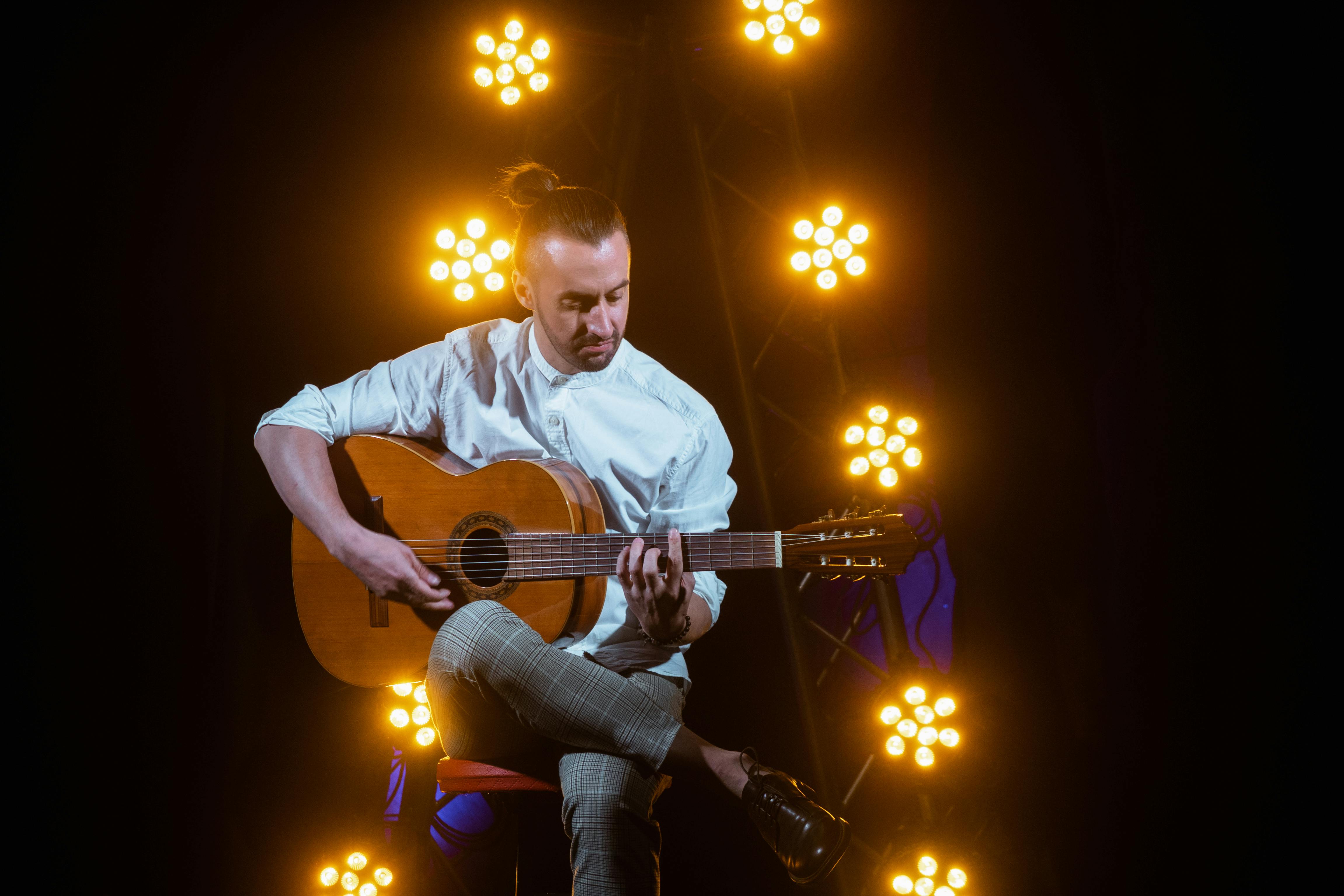 Man met gitaar op podium